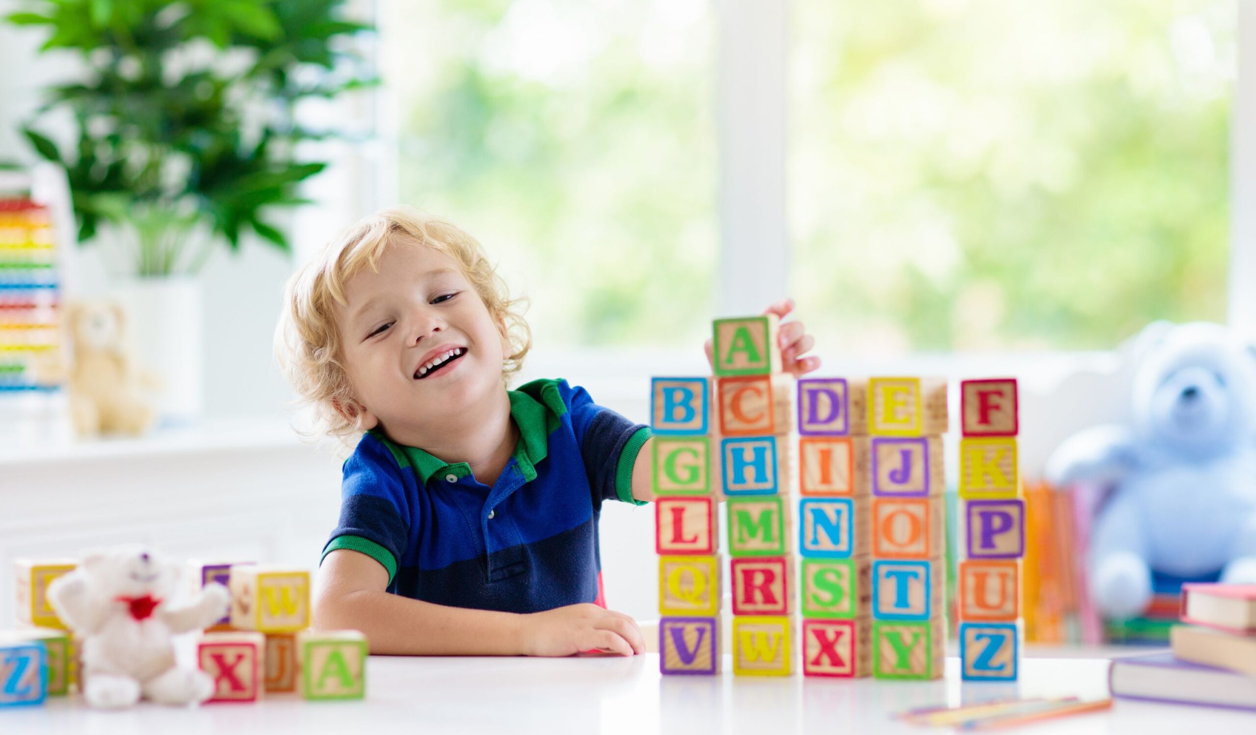 Child building early literacy skills at home by reading with parent. Parent and child practicing early literacy skills at home.